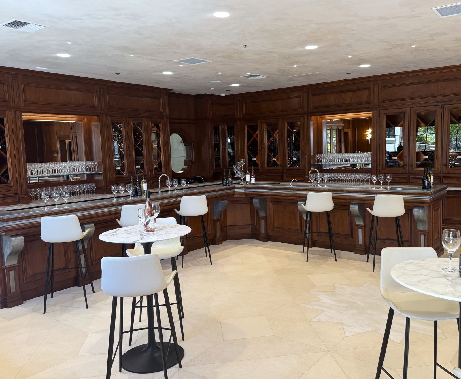 Tasting room with paneled bar and plaster-style ceiling
